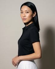 Women's SwingFree™ Performance Polo in Black, studio three-quarter view