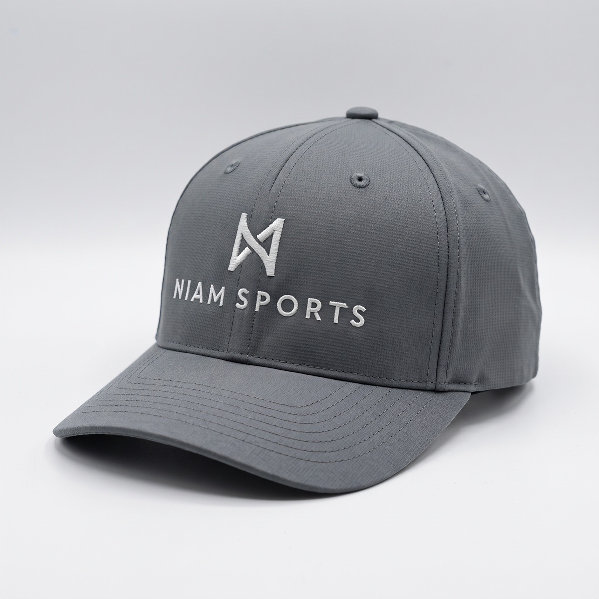 NIAM Sports Performance Golf Cap in Charcoal, structured five-panel crown with pre-curved visor and white embroidered logo