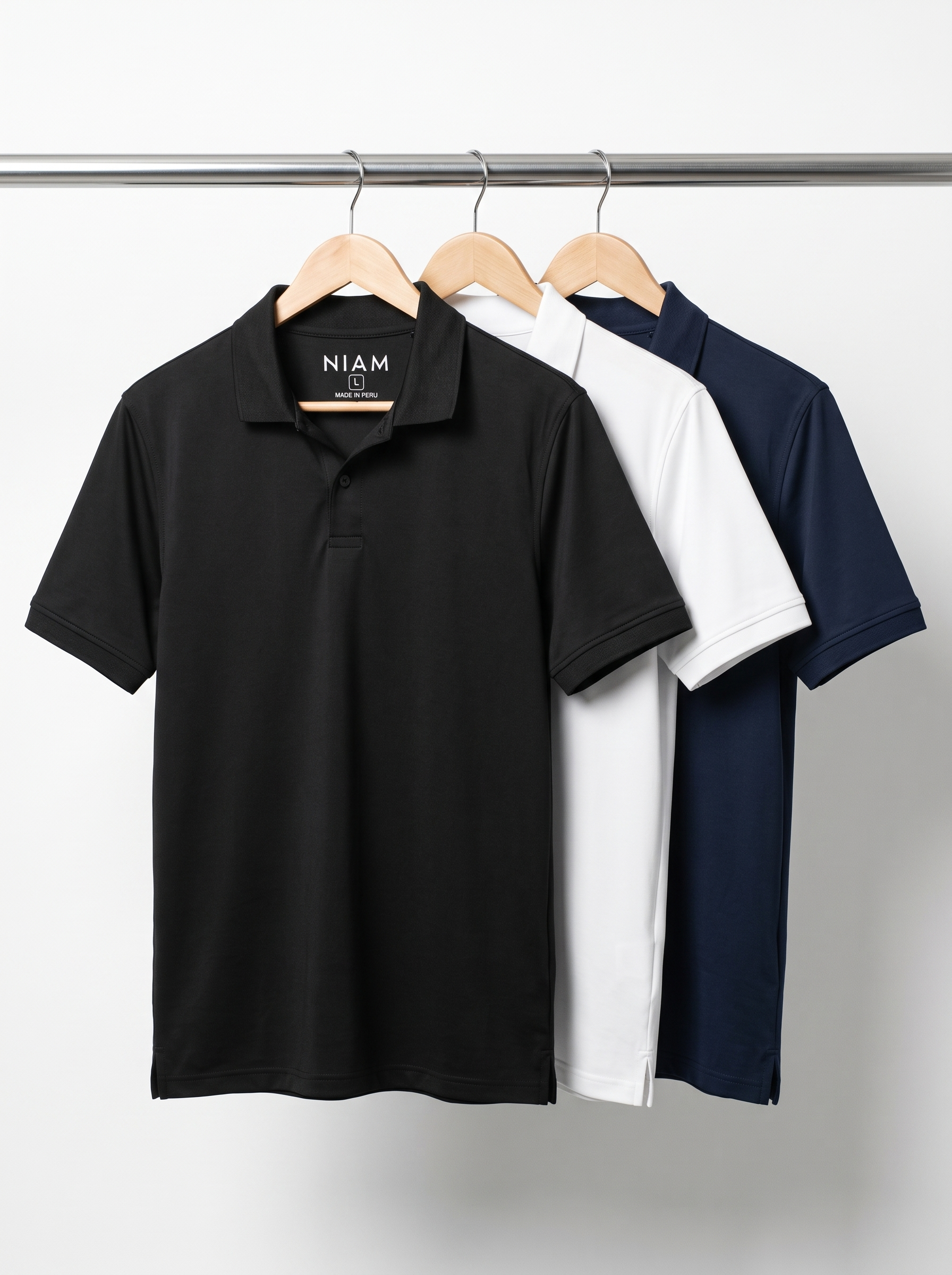 Three men's SwingFree performance polos on a studio rail