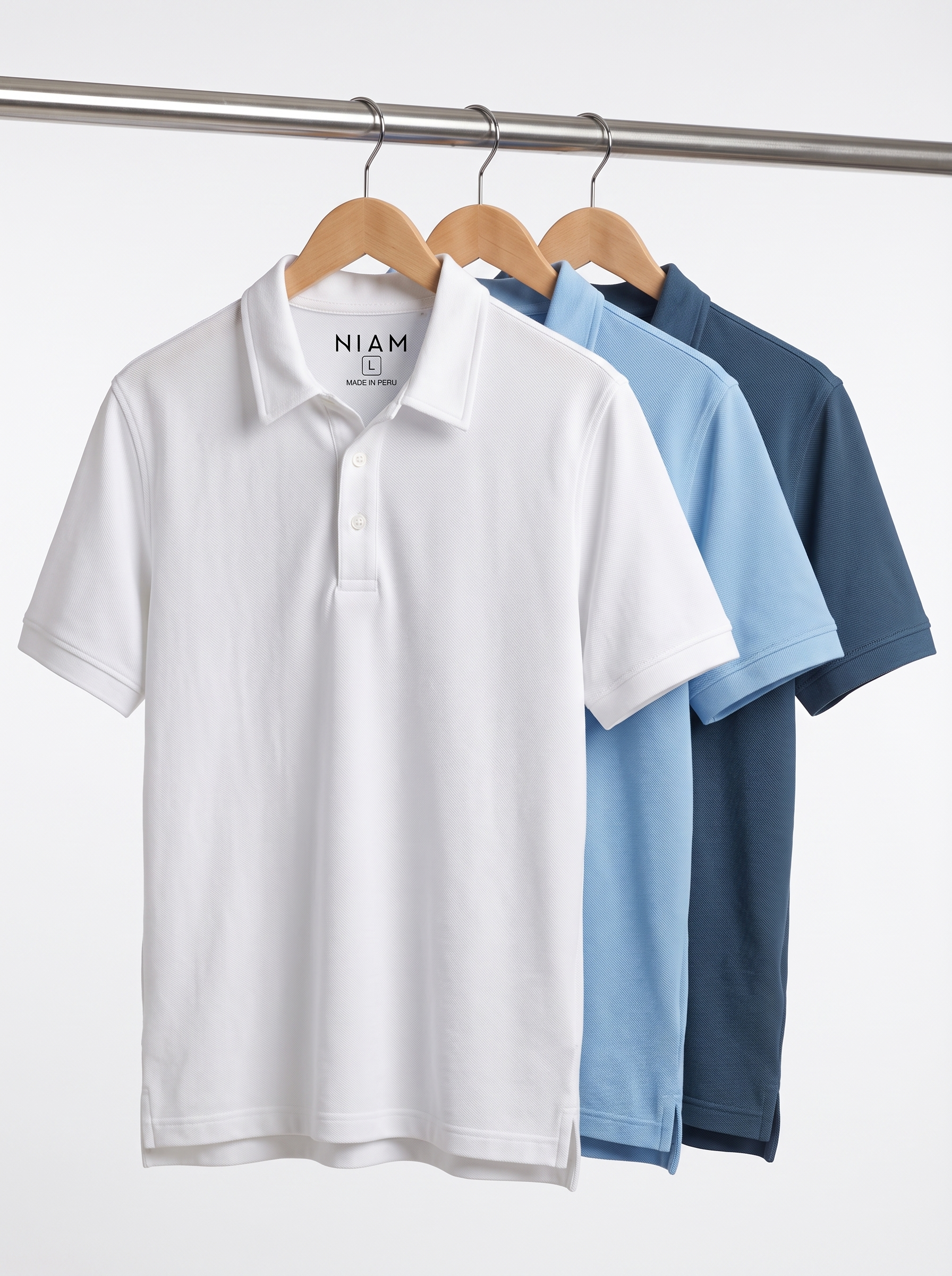 Three men's 3-button pique polos on a studio rail
