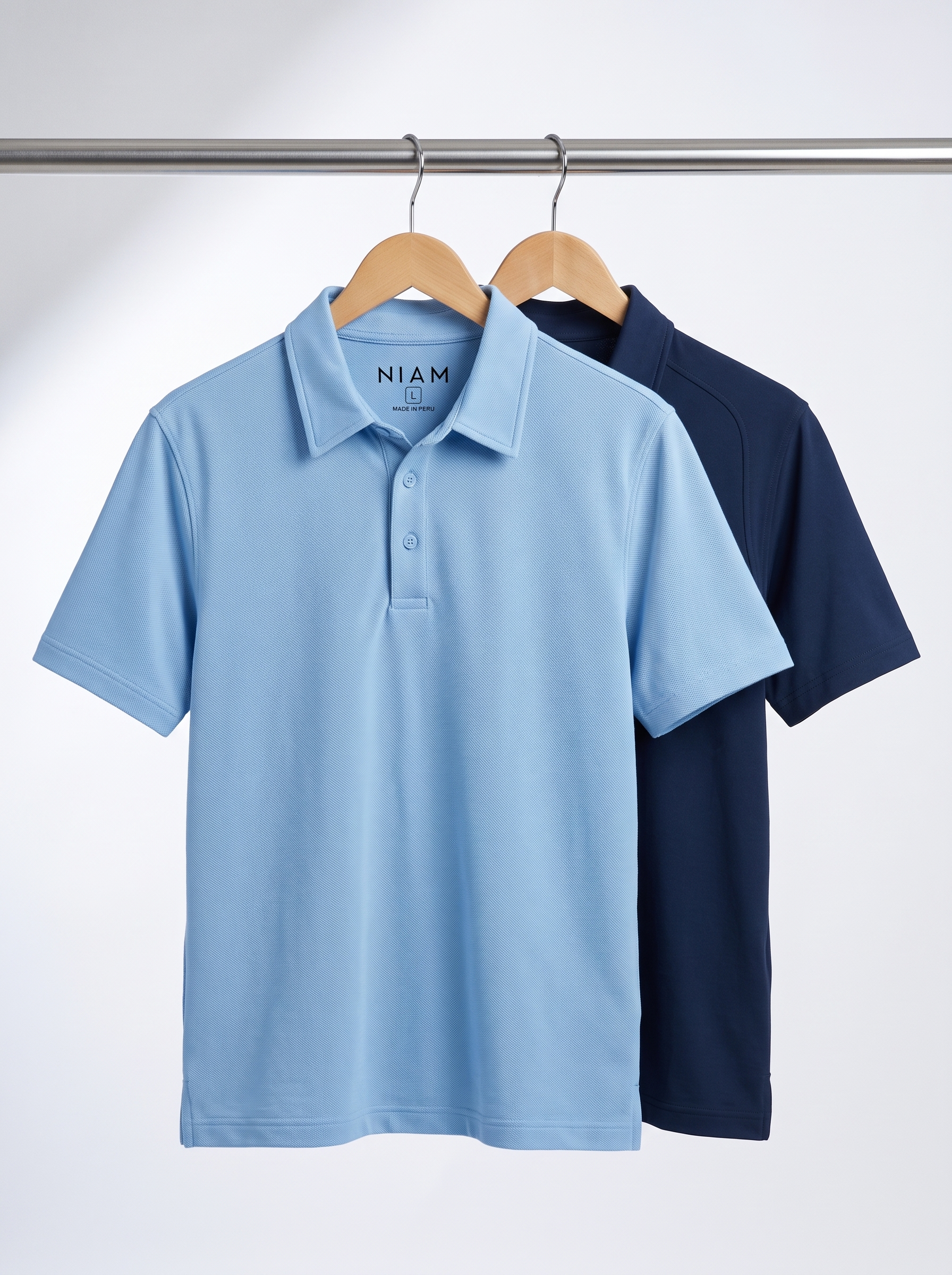 A pique polo and a performance polo on a studio rail