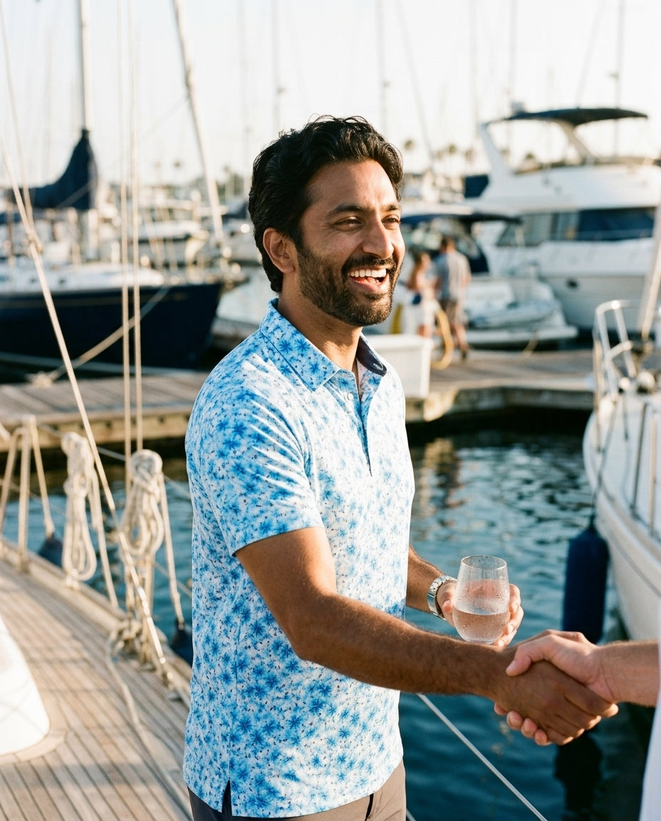 Man in aqua Hawaiian floral NIAM performance polo, lifestyle on course